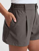 grey mid rise shorts with pockets and an elastic waistband with belt loops.